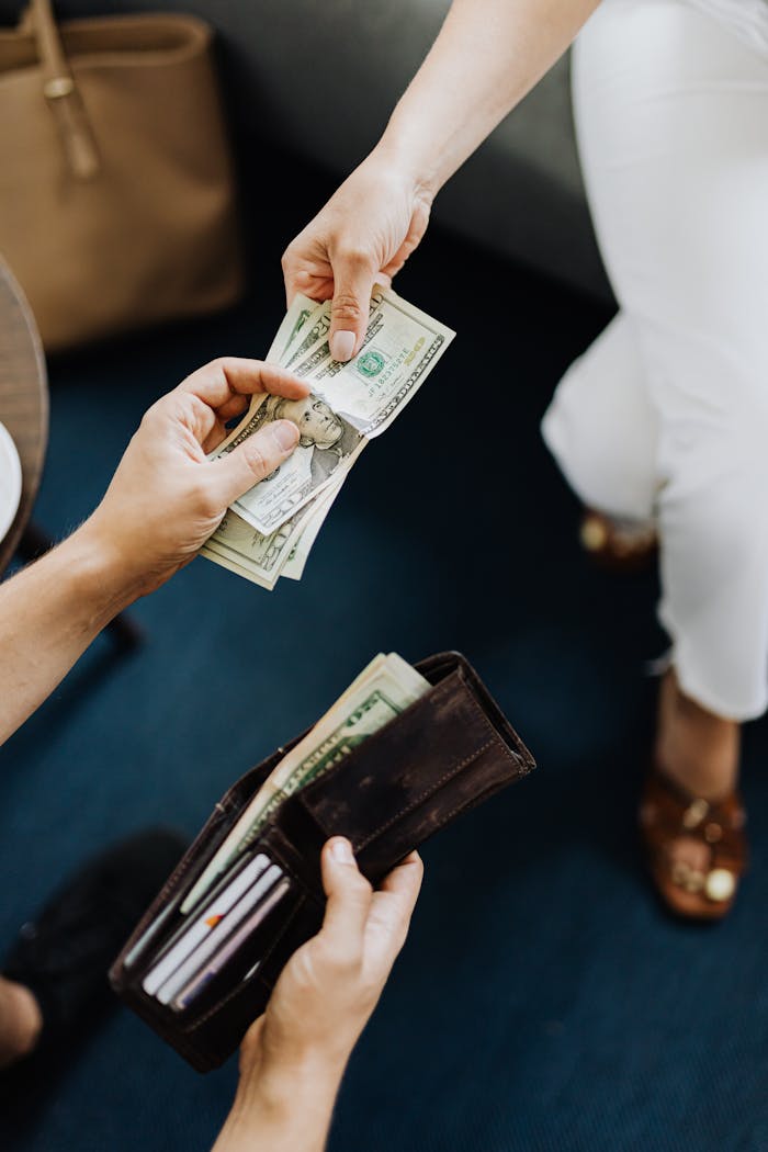 Crafting Captivating Headlines: Your awesome post title goes here Close-up of hands exchanging cash, representing a financial transaction or payment.